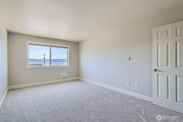 2514 57th Ave SW Unit 301, Seattle, WA 98116 - carpeted empty room with baseboards