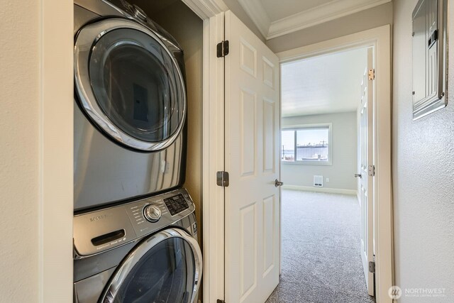2514 57th Ave SW Unit 301, Seattle, WA 98116 - laundry room featuring stacked washer / drying machine, carpet flooring, and ornamental molding