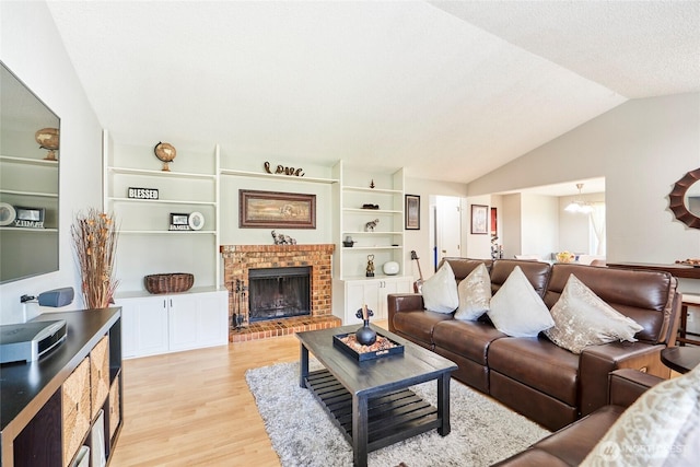 2003 SW 307th St Unit B, Federal Way, WA 98023 - living area featuring light wood finished floors, vaulted ceiling, a brick fireplace, and built in features