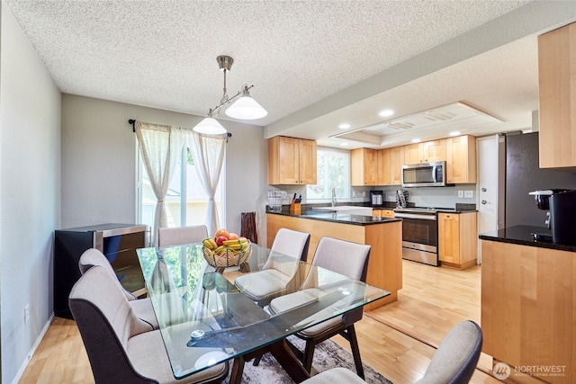 2003 SW 307th St Unit B, Federal Way, WA 98023 - dining space with light wood finished floors, a textured ceiling, recessed lighting, and a raised ceiling