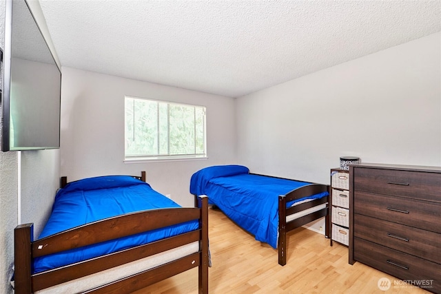 2003 SW 307th St Unit B, Federal Way, WA 98023 - bedroom with wood finished floors and a textured ceiling
