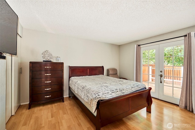 2003 SW 307th St Unit B, Federal Way, WA 98023 - bedroom featuring access to exterior, light wood-style flooring, french doors, and a textured ceiling