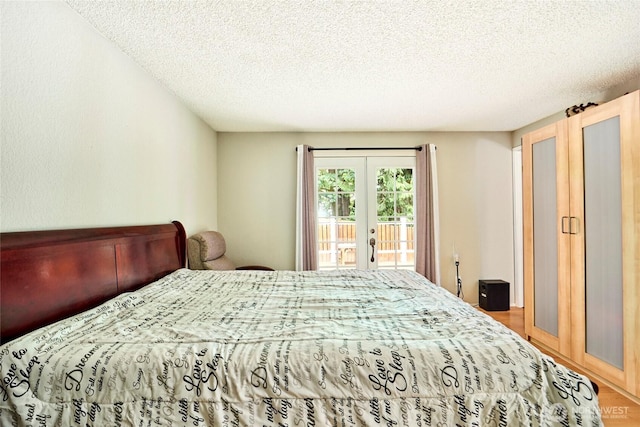 2003 SW 307th St Unit B, Federal Way, WA 98023 - bedroom featuring french doors, access to outside, wood finished floors, and a textured ceiling