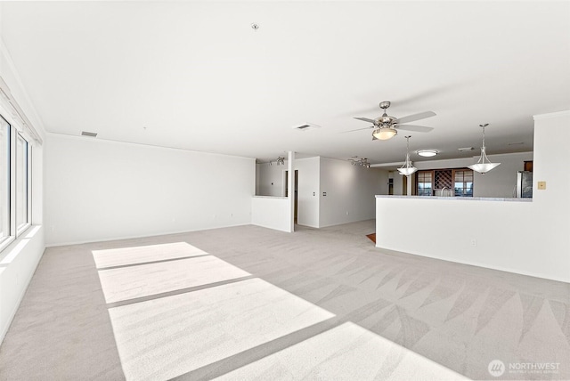 3201 Pacific Ave Unit 602, Tacoma, WA 98418 - unfurnished living room featuring light colored carpet, healthy amount of natural light, and ceiling fan
