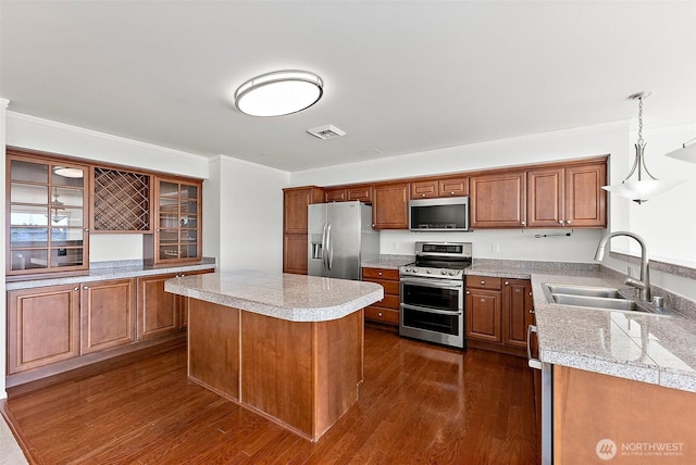 3201 Pacific Ave Unit 602, Tacoma, WA 98418 - kitchen featuring stainless steel appliances, brown cabinets, tile counters, glass insert cabinets, and ornamental molding