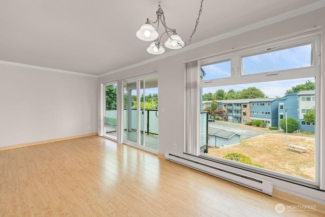 15146 65th Ave S Unit 518, Tukwila, WA 98188 - empty room featuring a baseboard heating unit, ornamental molding, a chandelier, and wood finished floors