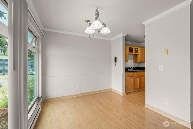 15146 65th Ave S Unit 518, Tukwila, WA 98188 - empty room with a chandelier, light wood-style flooring, plenty of natural light, a wainscoted wall, and ornamental molding