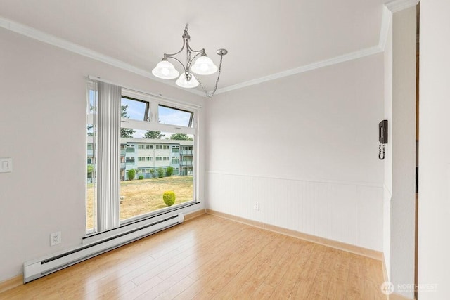 15146 65th Ave S Unit 518, Tukwila, WA 98188 - unfurnished room with a baseboard radiator, a chandelier, ornamental molding, wood finished floors, and a wainscoted wall