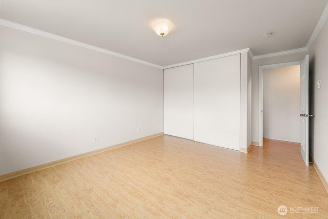 15146 65th Ave S Unit 518, Tukwila, WA 98188 - unfurnished bedroom featuring light wood-type flooring, crown molding, and a closet