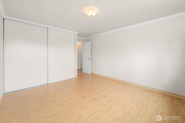 15146 65th Ave S Unit 518, Tukwila, WA 98188 - unfurnished bedroom with wood finished floors, ornamental molding, and a closet