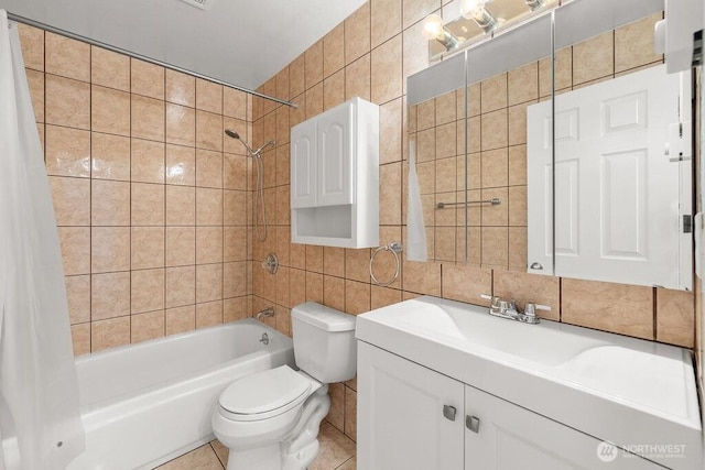 15146 65th Ave S Unit 518, Tukwila, WA 98188 - bathroom with tile walls, shower / tub combo with curtain, vanity, decorative backsplash, and tile patterned flooring