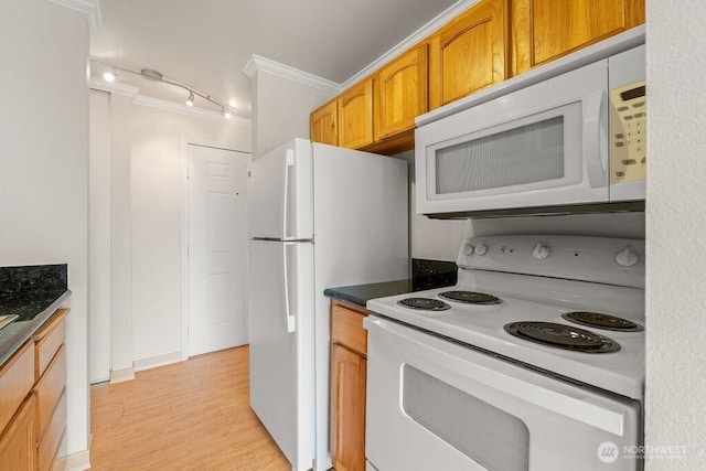 15146 65th Ave S Unit 518, Tukwila, WA 98188 - kitchen with white appliances, track lighting, ornamental molding, light wood finished floors, and dark countertops