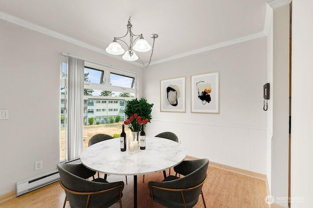 15146 65th Ave S Unit 518, Tukwila, WA 98188 - dining area with baseboard heating, a chandelier, light wood-style floors, ornamental molding, and wainscoting