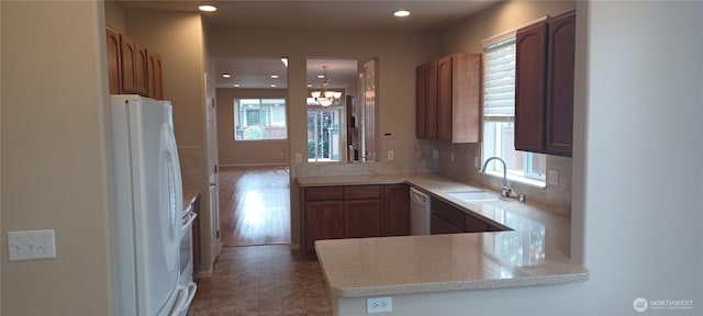 5000 Cypress Loop NE, Lacey, WA 98516 - kitchen featuring healthy amount of natural light, white appliances, a chandelier, a peninsula, and recessed lighting