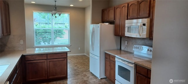 5000 Cypress Loop NE, Lacey, WA 98516 - kitchen featuring white appliances, light countertops, a chandelier, pendant lighting, and decorative backsplash