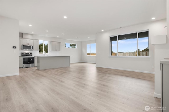 14756 88th Way SE Unit 10, Yelm, WA 98597 - unfurnished living room with light wood-style floors and recessed lighting