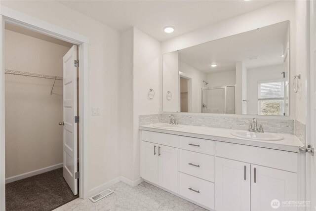 14756 88th Way SE Unit 10, Yelm, WA 98597 - full bath featuring a shower stall, double vanity, a walk in closet, recessed lighting, and tile patterned floors