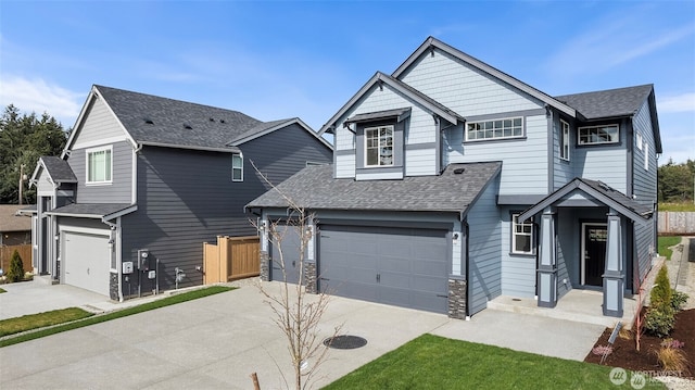 14756 88th Way SE Unit 10, Yelm, WA 98597 - view of front of property with driveway, an attached garage, and a shingled roof
