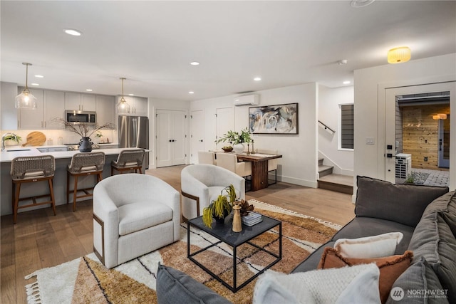 2616 E Roy St, Seattle, WA 98112 - living area with an AC wall unit, light wood-style floors, stairway, and recessed lighting