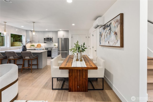 2616 E Roy St, Seattle, WA 98112 - dining room with a wall mounted AC, light wood-style floors, and recessed lighting