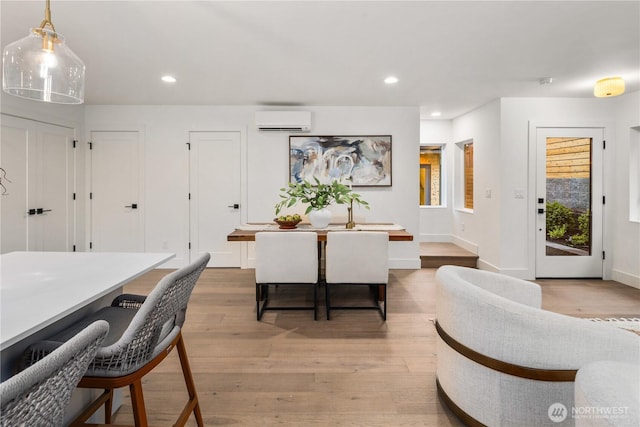 2616 E Roy St, Seattle, WA 98112 - dining room featuring an AC wall unit, light wood-style flooring, and recessed lighting
