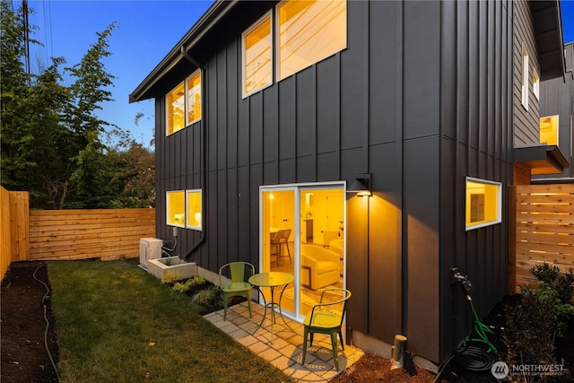 2616 E Roy St, Seattle, WA 98112 - rear view of house with board and batten siding and a fenced backyard
