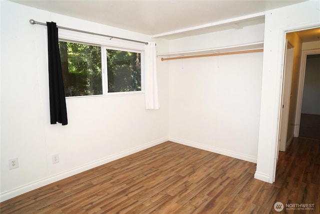 4011 147th Pl SE, Bellevue, WA 98006 - unfurnished bedroom with wood finished floors and baseboards