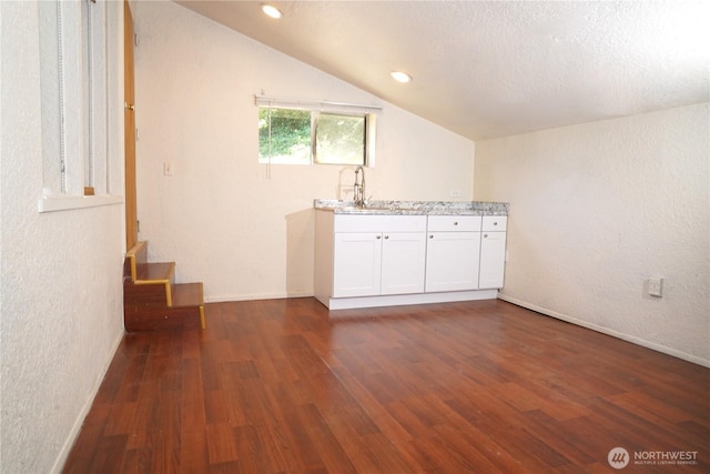 4011 147th Pl SE, Bellevue, WA 98006 - unfurnished living room featuring dark wood finished floors, lofted ceiling, a textured wall, and recessed lighting
