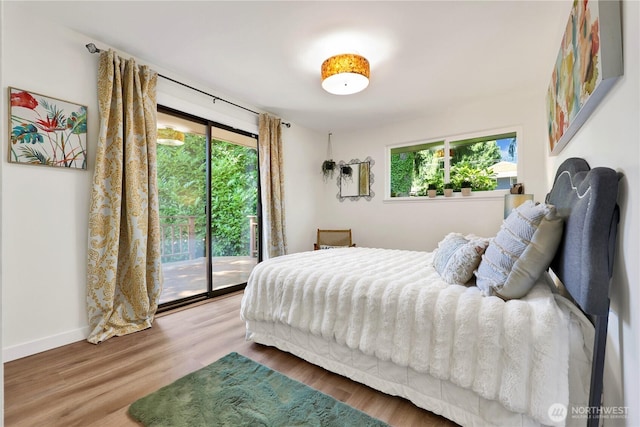 10507 NE 193rd St, Bothell, WA 98011 - bedroom featuring access to outside, multiple windows, and wood finished floors