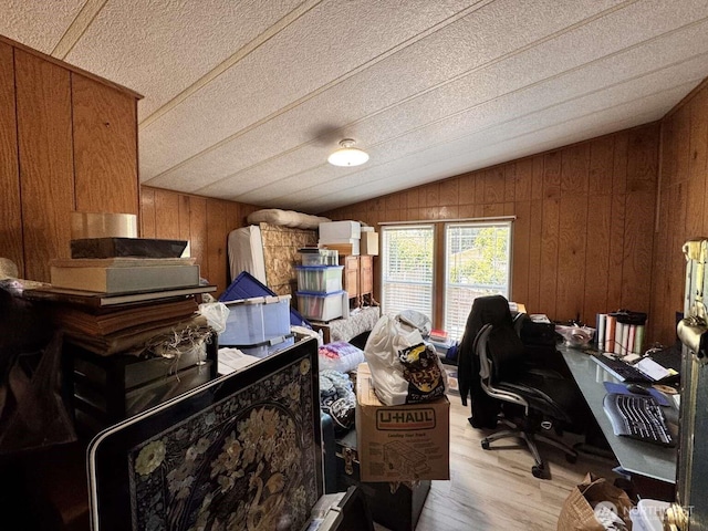 8839 Daffodil Ln SE, Olympia, WA 98513 - office area featuring lofted ceiling, wooden walls, light wood finished floors, and a textured ceiling