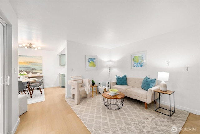 12504 NE 142nd Ln Unit C102, Kirkland, WA 98034 - living room with light wood finished floors and a chandelier