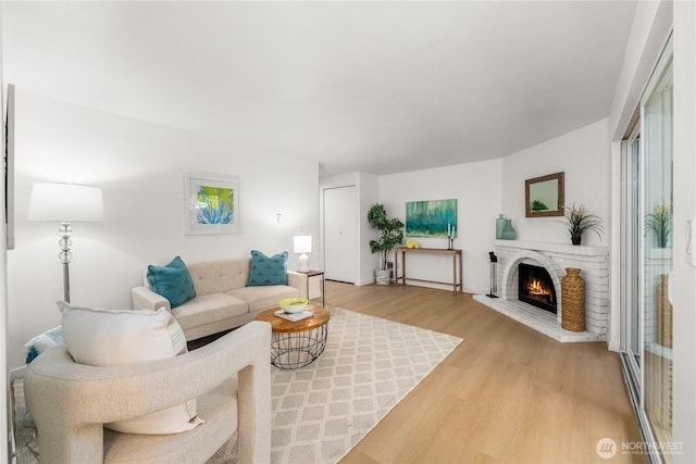 12504 NE 142nd Ln Unit C102, Kirkland, WA 98034 - living room with light wood finished floors and a brick fireplace
