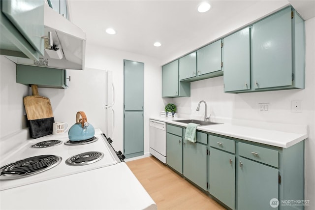 12504 NE 142nd Ln Unit C102, Kirkland, WA 98034 - kitchen with white appliances, range hood, light wood-style flooring, light countertops, and recessed lighting