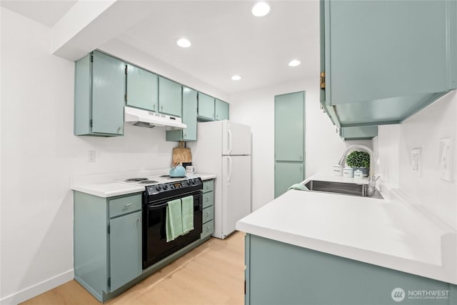 12504 NE 142nd Ln Unit C102, Kirkland, WA 98034 - kitchen featuring black / electric stove, under cabinet range hood, freestanding refrigerator, recessed lighting, and light wood finished floors
