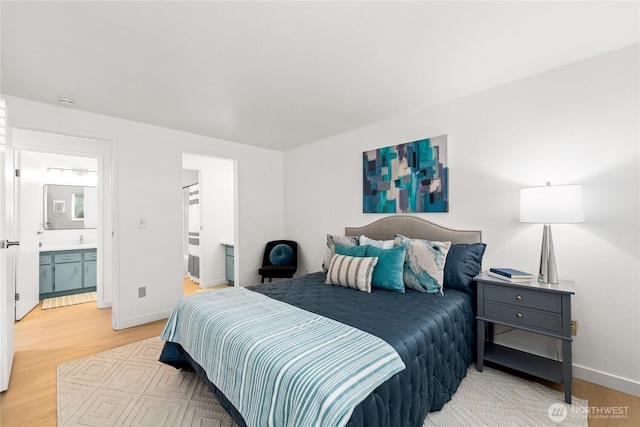 12504 NE 142nd Ln Unit C102, Kirkland, WA 98034 - bedroom with light wood-style floors and ensuite bathroom