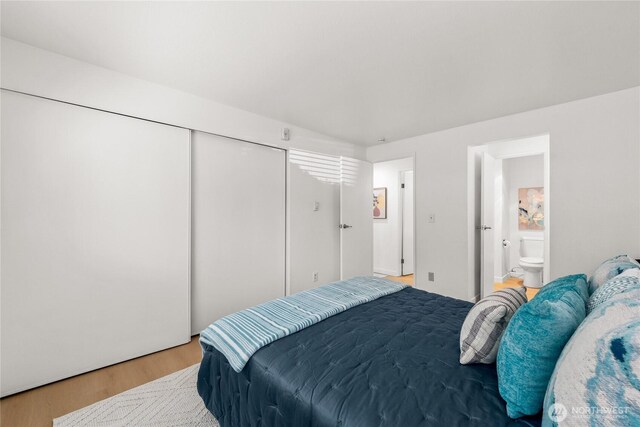 12504 NE 142nd Ln Unit C102, Kirkland, WA 98034 - bedroom with wood finished floors, a closet, and ensuite bath