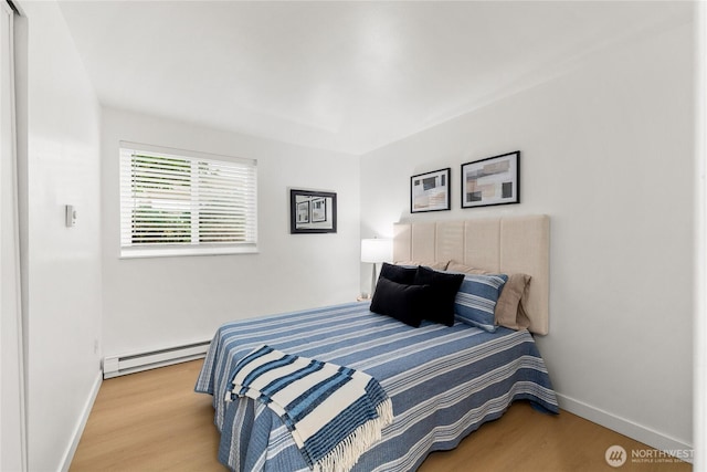 12504 NE 142nd Ln Unit C102, Kirkland, WA 98034 - bedroom featuring baseboard heating and wood finished floors