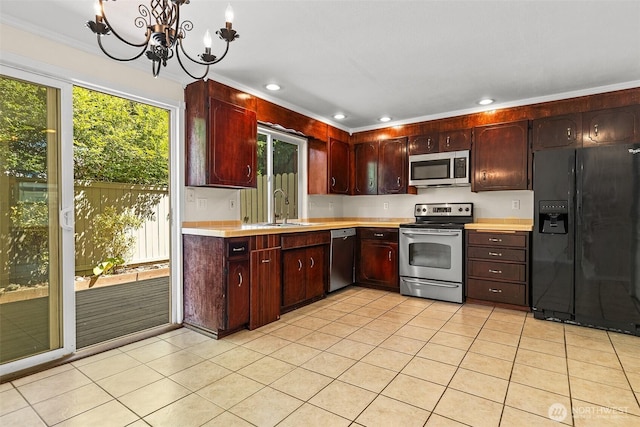 2621 Mountain View Ave W Unit 5B, Tacoma, WA 98466 - kitchen featuring appliances with stainless steel finishes, light countertops, a chandelier, light tile patterned floors, and recessed lighting