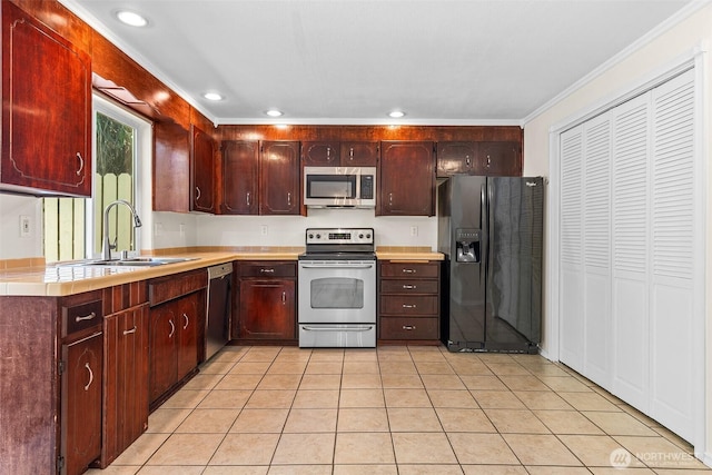 2621 Mountain View Ave W Unit 5B, Tacoma, WA 98466 - kitchen featuring appliances with stainless steel finishes, light tile patterned floors, crown molding, recessed lighting, and tile countertops