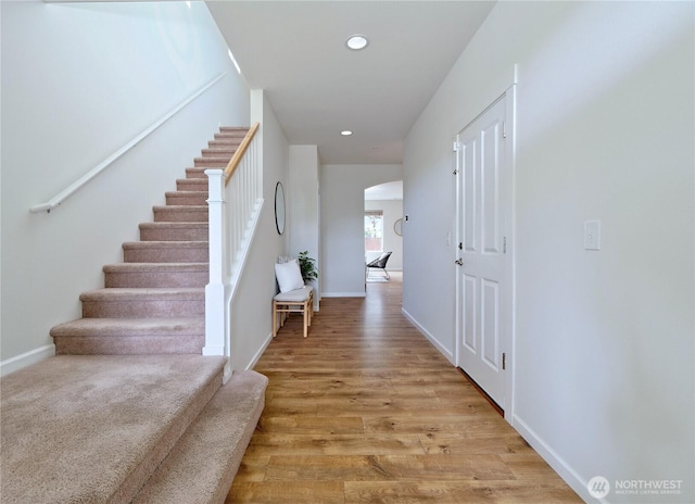 16271 SE 181st St, Renton, WA 98058 - corridor featuring arched walkways, stairway, light wood-type flooring, and recessed lighting