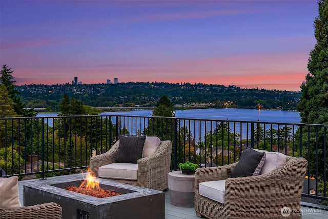 3865 46th Ave NE, Seattle, WA 98105 - balcony at dusk with an outdoor fire pit and a water view