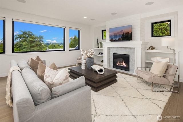 3865 46th Ave NE, Seattle, WA 98105 - living room with wood finished floors, plenty of natural light, a fireplace with flush hearth, and recessed lighting