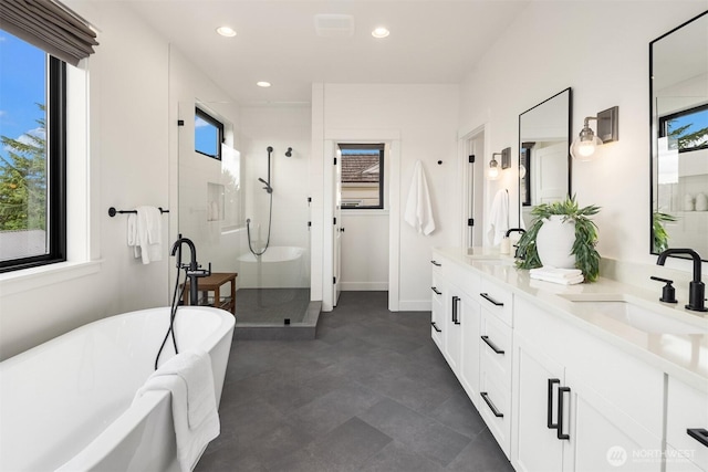 3865 46th Ave NE, Seattle, WA 98105 - bathroom featuring plenty of natural light, double vanity, a shower stall, and recessed lighting
