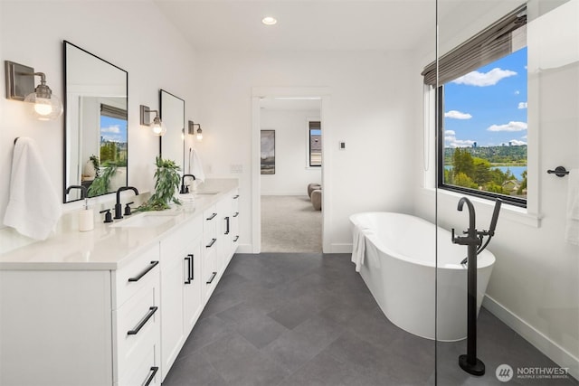 3865 46th Ave NE, Seattle, WA 98105 - full bathroom with double vanity, a freestanding bath, and recessed lighting