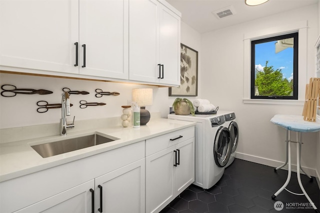 3865 46th Ave NE, Seattle, WA 98105 - laundry room featuring cabinet space, washer and dryer, and dark tile patterned floors
