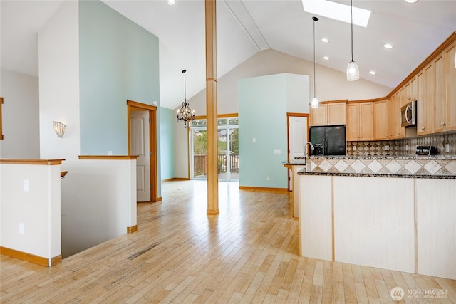 4824 Willow Dr, Blaine, WA 98230 - kitchen featuring black refrigerator with ice dispenser, stainless steel microwave, light wood finished floors, backsplash, and light brown cabinetry