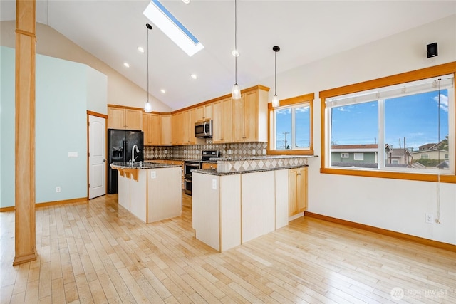 4824 Willow Dr, Blaine, WA 98230 - kitchen featuring stainless steel appliances, lofted ceiling, a skylight, decorative backsplash, and light brown cabinets