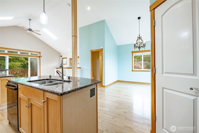 4824 Willow Dr, Blaine, WA 98230 - kitchen featuring lofted ceiling, light wood-style flooring, dishwasher, dark stone counters, and a ceiling fan