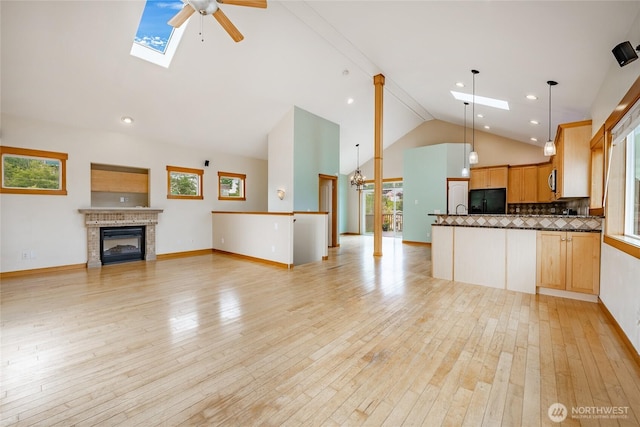 4824 Willow Dr, Blaine, WA 98230 - kitchen featuring open floor plan, black fridge, a skylight, high vaulted ceiling, and a ceiling fan