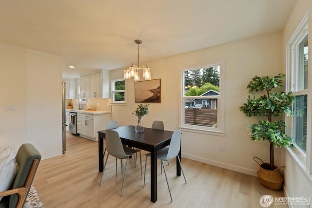 12302 5th Ave NE, Seattle, WA 98125 - dining room with light wood-style floors and a chandelier